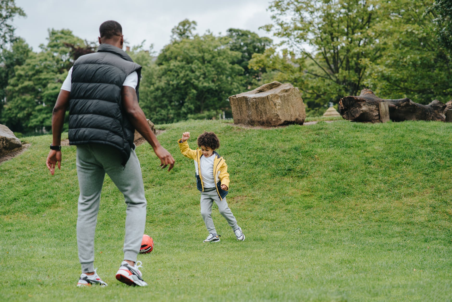 A dad and his kid playing sports to stay active. He is overcoming his excuses.